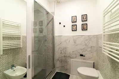 a bathroom with a toilet and a sink at Villa Borghese Luxury Place in Rome