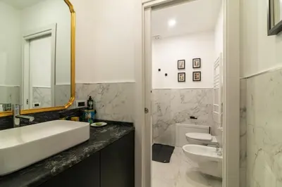 a bathroom with a sink and a toilet at Villa Borghese Luxury Place in Rome