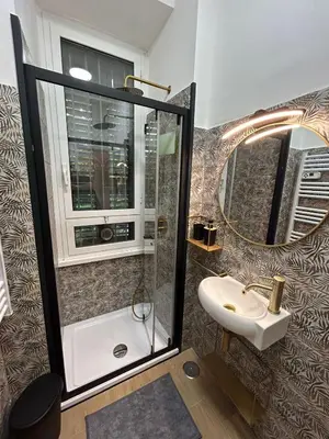 a bathroom with a shower and a sink and a mirror at D Guest House in Rome