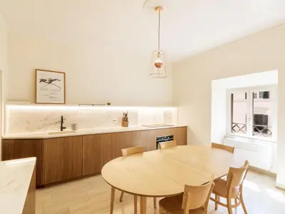 a kitchen and dining room with a wooden table at Apartment Alessandria Home by Interhome in Rome