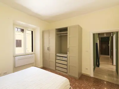 a bedroom with a bed and a walk in closet at Apartment Alessandria Home by Interhome in Rome
