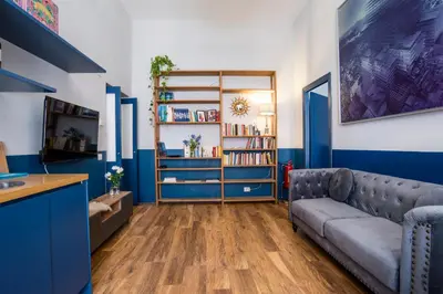 a living room with blue walls and a couch at La Trasteverina apartment in Rome