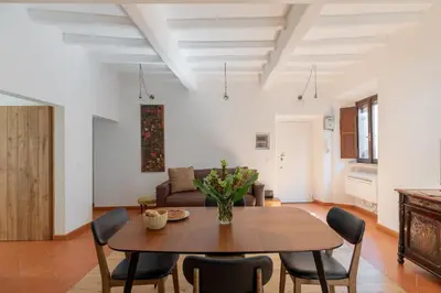 a living room with a wooden table and chairs at iFlat Peaceful brand new 2beds apt in Trastevere in Rome