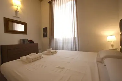 a bedroom with a white bed with two towels on it at Navona New Charming Apartment in Rome