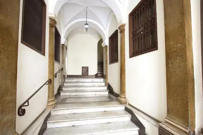 a hallway of an old building with stairs at Navona New Charming Apartment in Rome