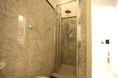 a shower with a glass door in a bathroom at Navona New Charming Apartment in Rome