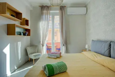 a bedroom with a large bed and a window at Casetta 79 in Rome