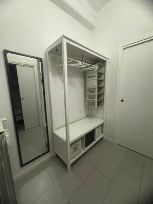 a white refrigerator with a mirror in a room at Casetta 79 in Rome