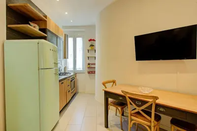 a kitchen with a refrigerator and a table and chairs at Casetta 79 in Rome