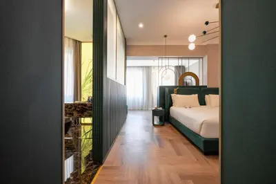 a bedroom with a bed and a large window at Je Rome Hotel in Rome