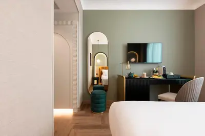 a hotel room with a bed and a mirror at Je Rome Hotel in Rome