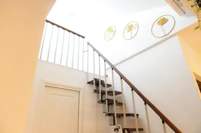 a staircase with white walls and a white stair case at Trastevere golden luxury loft in Rome