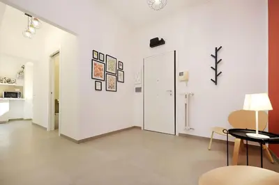 a large white room with a table and a mirror at Basilica San Paolo Nuvola EUR Modern apartment in Rome