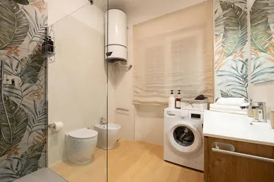 a bathroom with a washing machine and a sink at The Ciccins Apartment in Rome by Hostand in Rome