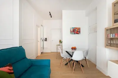 a living room with a blue couch and a table at The Ciccins Apartment in Rome by Hostand in Rome