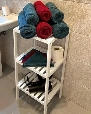 a white towel rack in a bathroom with towels at Lilia Charming Flat in Rome
