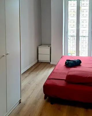a bedroom with a red bed with a red blanket at Lilia Charming Flat in Rome
