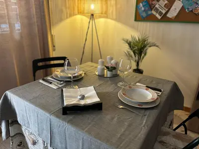 a table with plates and wine glasses on it at Accogliente Appartamento Roma in Rome