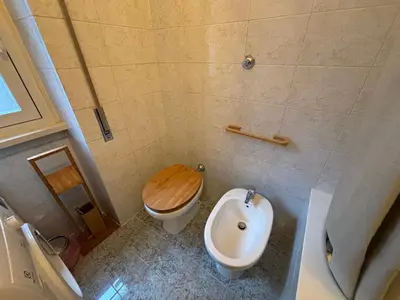 a bathroom with a toilet and a bidet at Accogliente Appartamento Roma in Rome