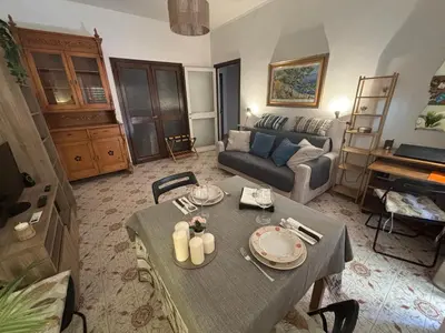a living room with a table and a couch at Accogliente Appartamento Roma in Rome