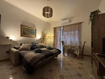 a bedroom with a bed and a table in it at Accogliente Appartamento Roma in Rome