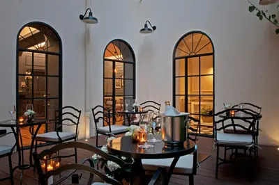 a dining room with tables and chairs and windows at The Fifteen Keys Hotel in Rome