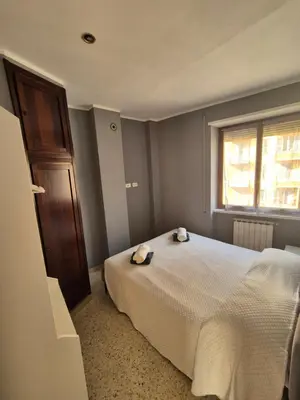 a bedroom with a white bed and a window at Nice house in Roma Esquilino Colosseum in Rome