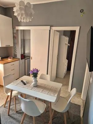 a dining room with a white table and chairs at Nice house in Roma Esquilino Colosseum in Rome
