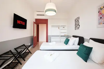 a living room with two beds in a room at Elegant Apartment with view of Castel Sant'Angelo in Rome