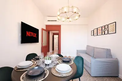 a dining room with a table and a couch at Elegant Apartment with view of Castel Sant'Angelo in Rome