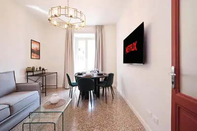 a living room with a table and a couch at Elegant Apartment with view of Castel Sant'Angelo in Rome
