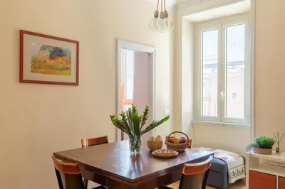a dining room with a wooden table and chairs at iFlat Bright & Comfy 2-Bedroom Apt near Vatican in Rome