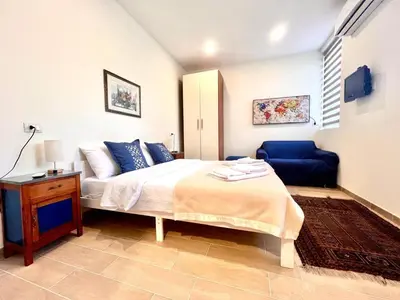 a bedroom with a bed and a blue chair at Sunshine Eco Residence in Rome