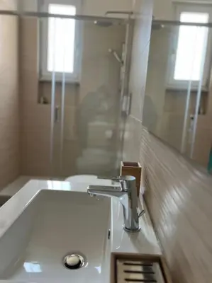 a bathroom with a sink and a mirror at Sunshine Eco Residence in Rome