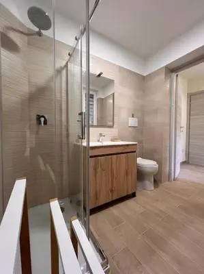 a bathroom with a shower and a sink and a toilet at Sunshine Eco Residence in Rome