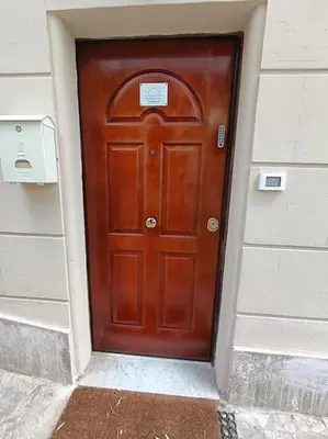 a wooden door on a building with a sign on it at Sunshine Eco Residence in Rome