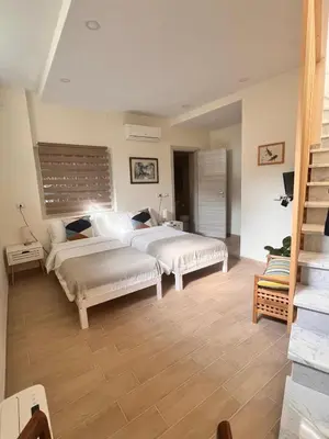 a bedroom with two beds and a staircase at Sunshine Eco Residence in Rome