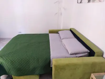 a bed in a room with a green bed frame at Home Fermi 80 in Rome