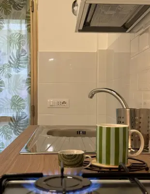 a kitchen counter with two cups on a stove at Home Fermi 80 in Rome