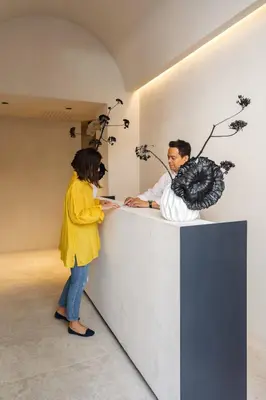 a man and a woman standing at a counter at C10 Boutique Hotel in Rome