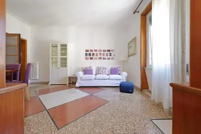 a living room with a white couch and purple pillows at Flaminio in Rome