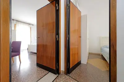 a large wooden door in a room with a bedroom at Flaminio in Rome
