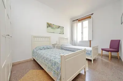 a bedroom with two beds and a purple chair at Flaminio in Rome
