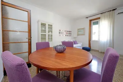 a dining room with a wooden table and purple chairs at Flaminio in Rome