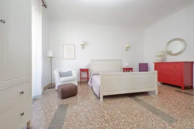 a bedroom with a bed and a chair and a mirror at Flaminio in Rome