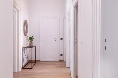 a hallway with white walls and a wooden floor at Pinturicchio's Key in Rome