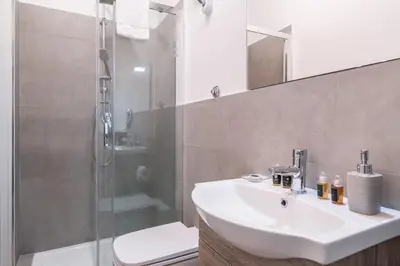 a bathroom with a sink and a shower at Pinturicchio's Key in Rome