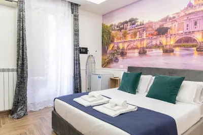 a bedroom with a large bed with a painting on the wall at Susy's Guest House Room San Pietro in Rome