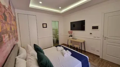 a living room with a couch and a tv at Susy's Guest House Room San Pietro in Rome