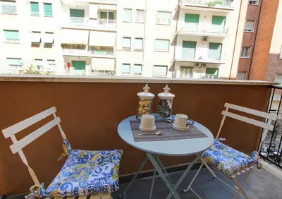 a table and two chairs on a balcony with coffee cups at Residenza Santa Barbara in Rome